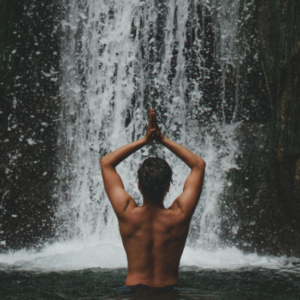 person under waterfall