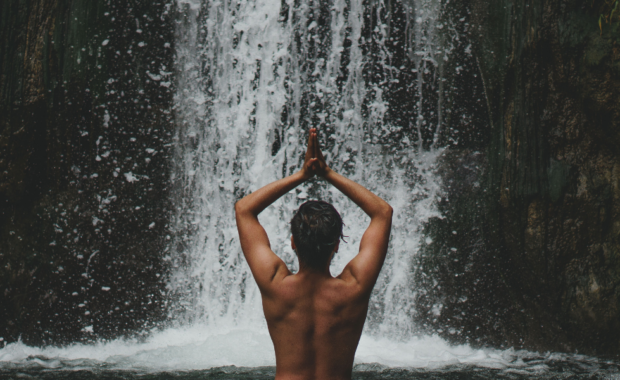 person in front of waterfall